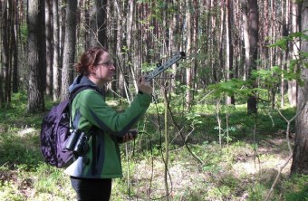 Eine Biologin steht mit Telemetrie-Antenne in einem weißrussischen Wald | © V. Grudinskaja